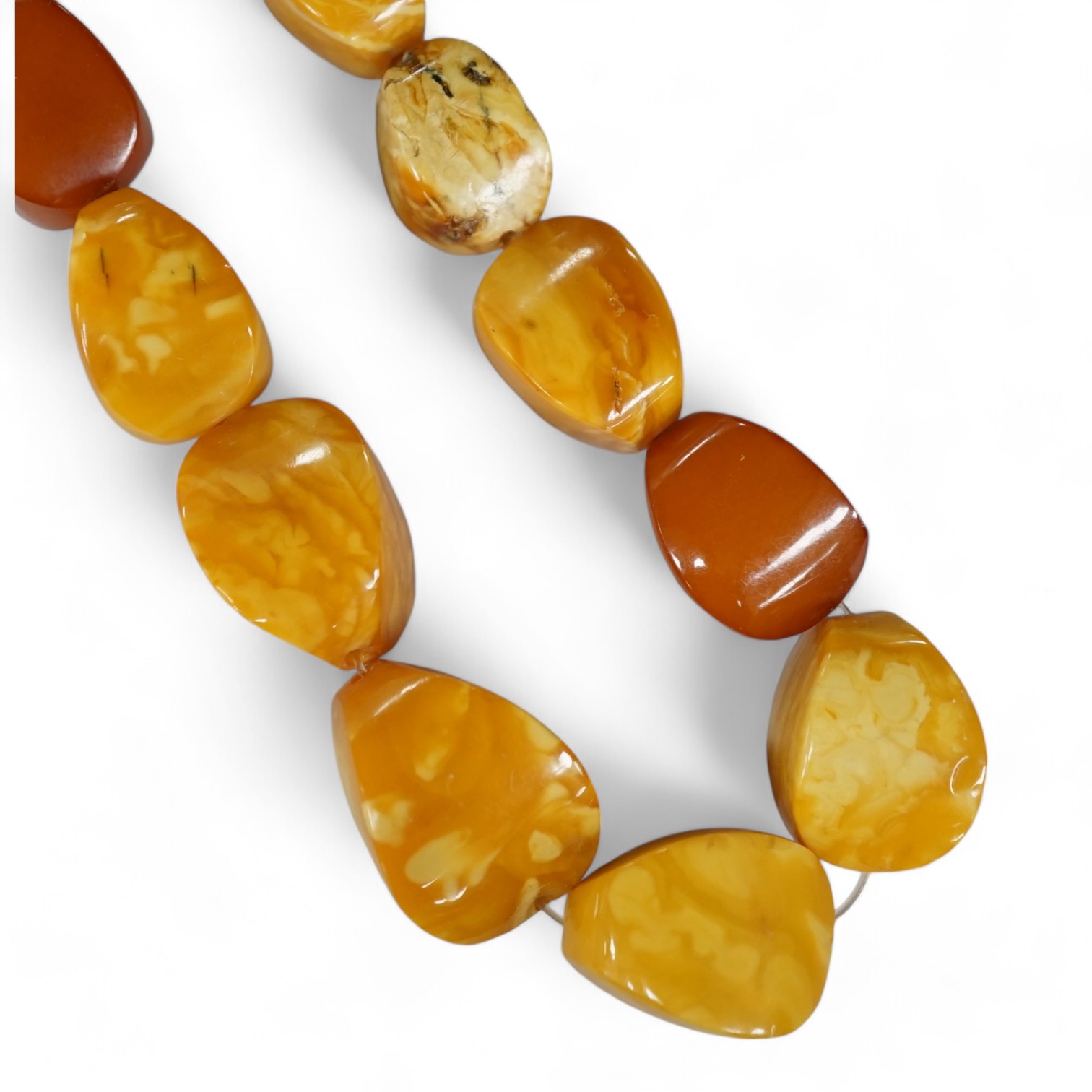 A single strand amber pebble bead necklace, 78cm, gross weight 93 grams. Condition - poor to fair